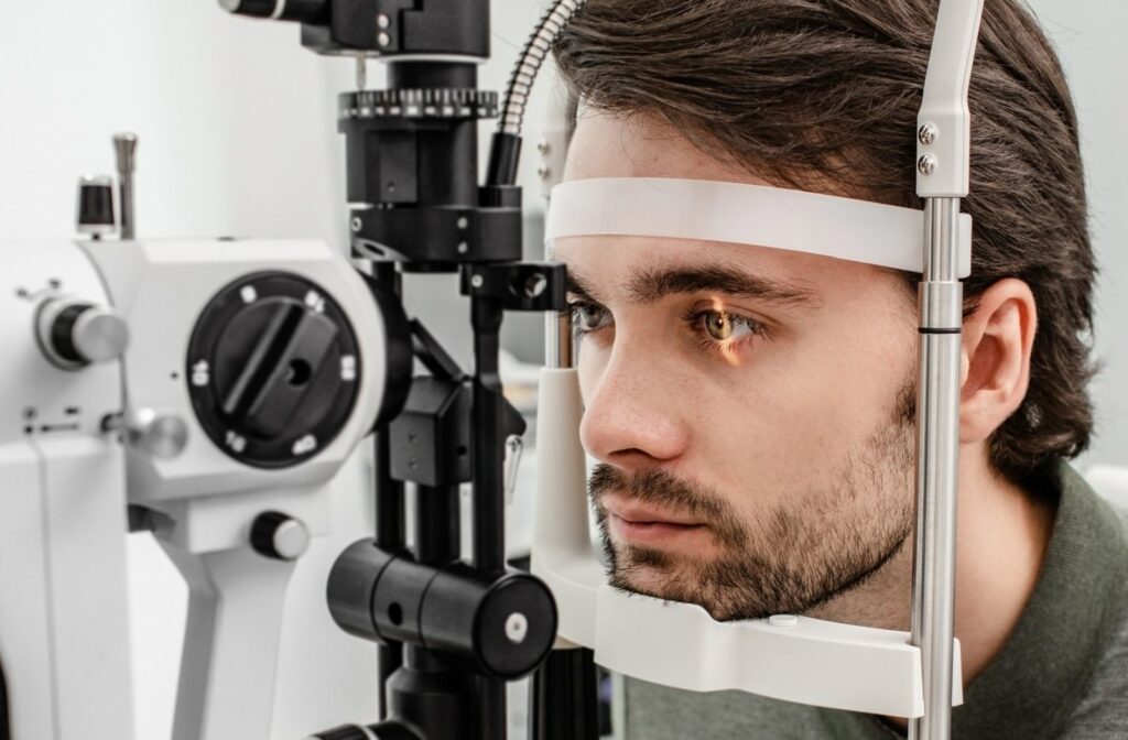 A man gets his eyes examined by a slit lamp at the optometrist's office